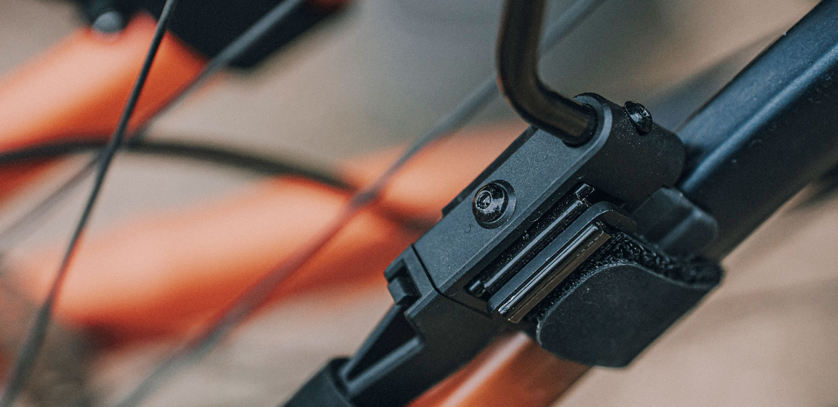 Detailaufnahme der Befestigung des Topeak TetraFender M2 an den Sitzstreben eines Fahrrads, Klettgurt und Schraubmechanismus sichtbar.